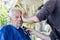 Old man getting his beard shaved by young skilled man at home