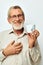 old man in glasses with a mug on a white background joyful