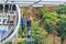 Old man with go pro camera on wrist is about to jump 207 meter bungy at AJ Hackett Sky Park on mountain forest background. Extreme