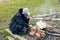 old man with a gray beard smokes in the village