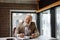 Old man with grey hair and beard working with enthusiasm despite his age