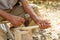 Old man handcrafting a wood sppon the traditional way of making tools in the villages of Romania and Eastern Europe