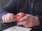 Old man hands peeling organic red yellow Pink Lady apple over a saucer