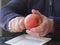 Old man hands peeling organic red yellow Pink Lady apple over a saucer