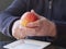 Old man hands peeling organic red yellow Pink Lady apple over a saucer