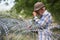 Old man on local stand near barbed wire