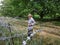 Old man on local stand near barbed wire