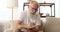 Old man marking with pencil while reading a book