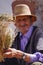 Old man medical herb salesman on the highway of the atlas mountains in Morocco