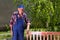 Old man painting bench in garden