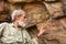 Old man points at the ancient bushman paintings