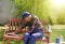 Old man repairing bench in garden