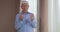 An old man with rosary beads praying