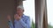 An old man with rosary beads praying