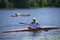 An old man rowing canoe on a river