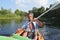 The old man rowing a kayak on the river