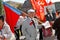 Old man with russian flag and newspapers takes part in the May day demonstration in Volgograd