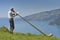 Old man singing at Alpen horn with Thun lake in background