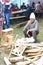 Old man sitting near cut woods, traditional lumber jack during country fair