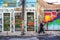 Old man smoking while walking along side walk with wall with colorful street art in the urban Lapa neighbourhood of Rio de Janeiro