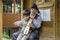 The old man teaches the boy to play traditional fiddle