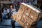 Old man, turkish senior worker, delivering a heavy package, holding a huge parcel on a cart during an afternoon in istanbul