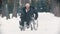 An old man veteran in a wheelchair trying to move on the snowy ground