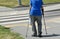 Old man walks with crutch