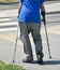 Old man walks with crutches