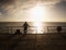 Old man watch the morning sea over pier handrail