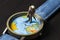 Old man on watches with world map. World travel photo banner. Senior traveler figurine.