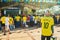 Old man wearing green and yellow watching a match of the world c