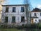 Old manor house surrounded by trees, partially inhabited