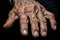 an old mans hands with wrinkled skin on a black background