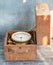 An old marine chronometer in a wooden case