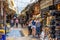 Old market near Monastiraki square in Athens, Greece. People visit stores and walk in market outdoors in city center