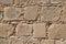 The old masonry wall is rectangular in different sizes beige