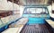 Old mattress place in back of blue pickup truck in vintage retro
