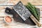 Old meat butcher cleaver. White wooden background. Top view