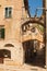 Old medieval city. Ancient stone street, houses with windows and shutters, duck lane