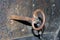 Old medieval dungeon key in rusty iron door