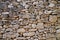 Old medieval high wall pebble stones background