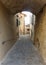 Old medieval passageway and stone buildings in Tuscany, Italy