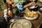 Old medieval plates, bowls, belts, earthenware and jugs on the set table.