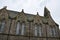 Old medieval Scottish stone church with clouds