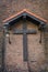 Old medieval style christian cross under a shed