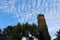 Old Mediterranean chimney with palm trees and blue sky in the background