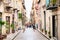 Old mediterranean steet with tourist in Cefalu, medieval city of