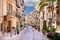 Old mediterranean steet with tourist in Cefalu, medieval city of