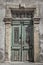 Old Medittaranean door in Cyprus with peeling paint but remnants of grandeur